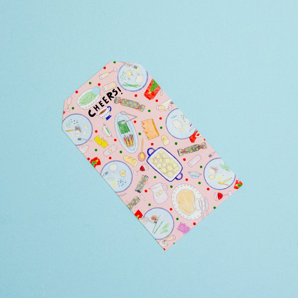 A gift tag with colourful food themed drawings on a blue background.