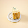 Block of blue cheese on a dish with a yellow background