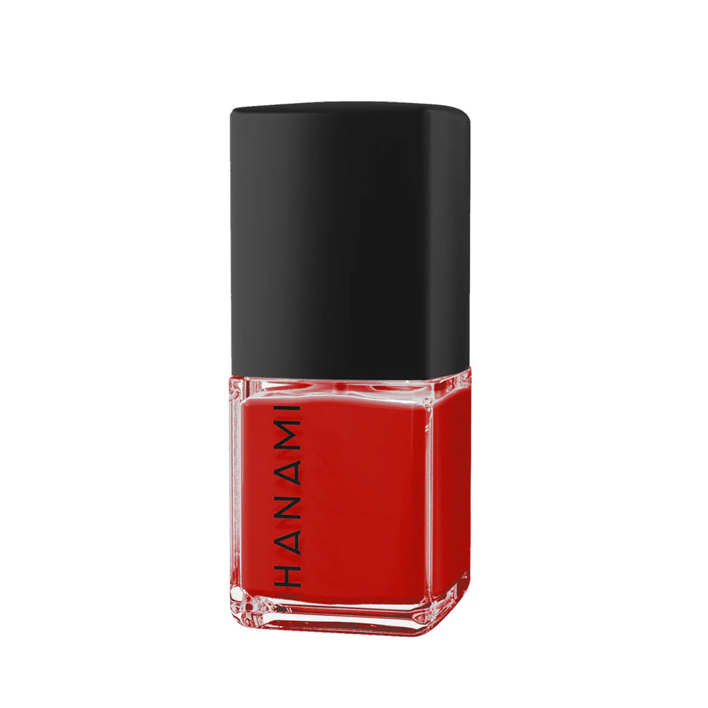 Red nail polish bottle with black cap on a white background