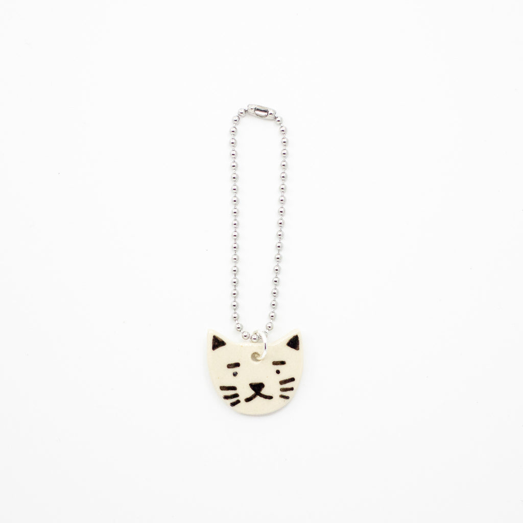 Cat-shaped charm on a white background