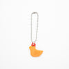 Orange chicken-shaped charm on a white background