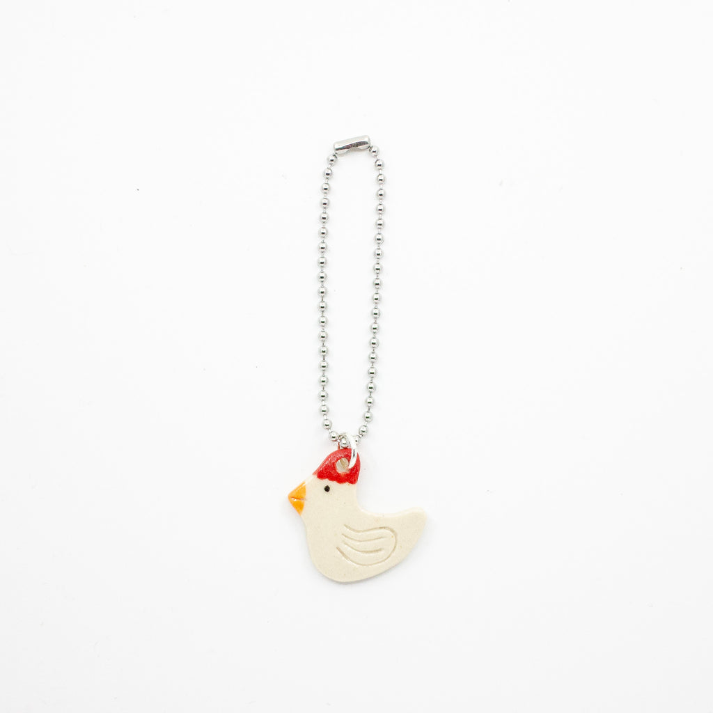 Keychain with a chicken-shaped charm on a white background