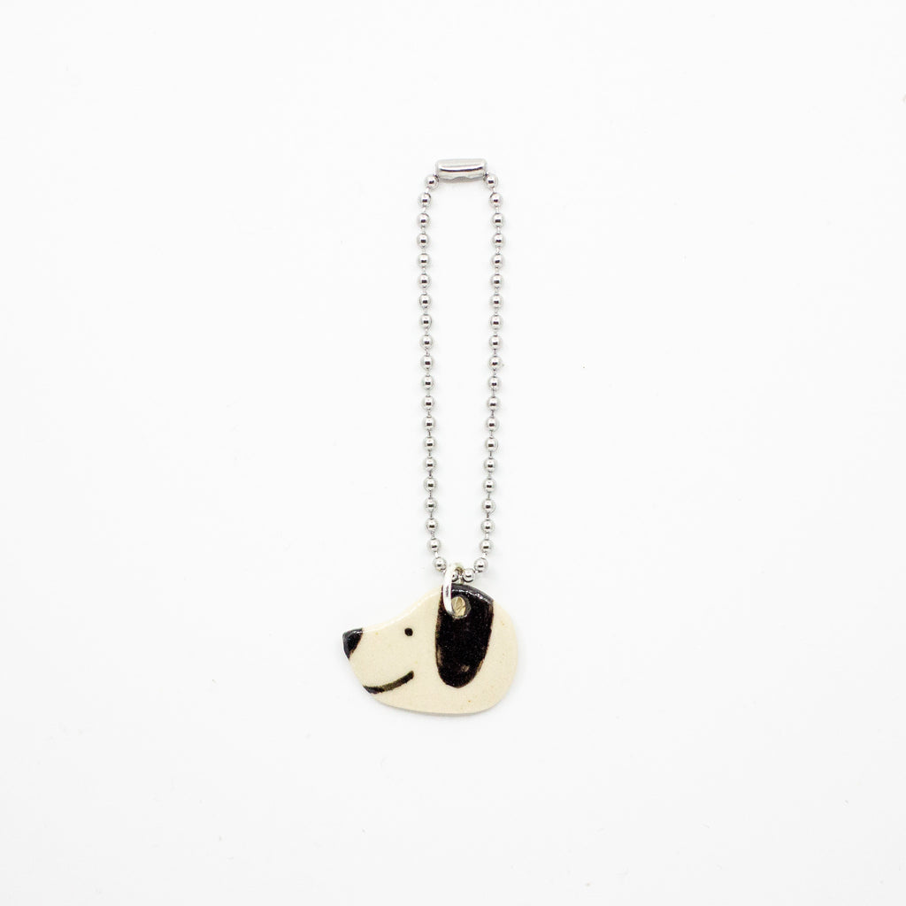 Keychain with a dog-shaped charm on a white background