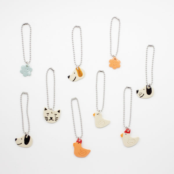 Set of animal-themed bag charms on white background
