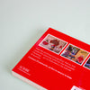 The back cover of a postcard booklet on a pale mint background. The cover features three small holiday-themed postcard photos, descriptive text, and the brand name SCRIBE near the bottom left.
