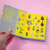 Open book with colourful illustrations on a pink background