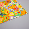 A close-up of a colourful abstract art print featuring bright yellow, orange, green, blue, and purple shapes, flowers, and doodles on a light grey background.