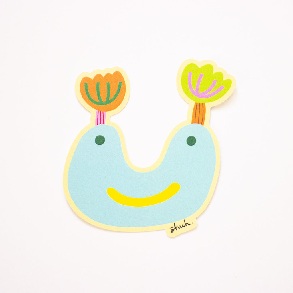 Cora sticker, an aqua coloured monster with tulip ears. 