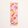 A tall, narrow rectangular bookmark featuring a playful abstract pattern in pink, orange, yellow, and red on a white background, with the text 'shuh.' and 'shuhlee.com' printed at the bottom.