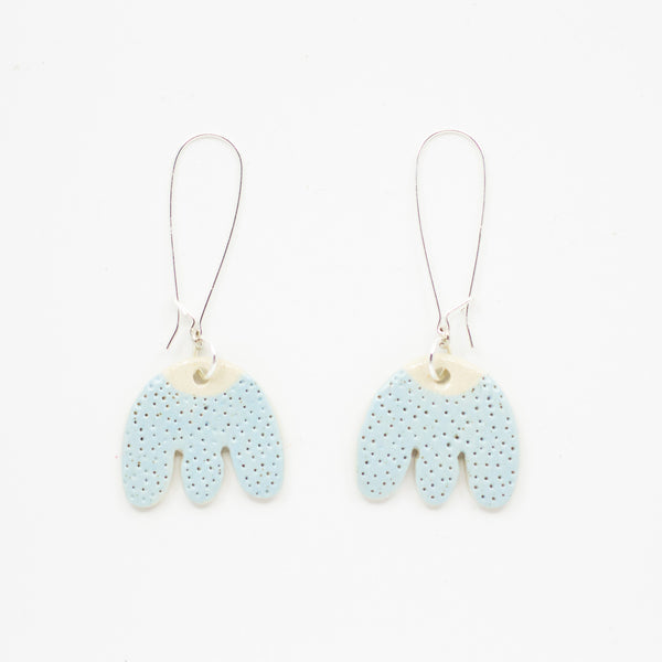 Pair of light blue earrings with textured design on a white background