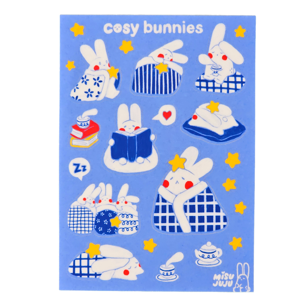 A blue sticker sheet featuring cute cartoon bunnies in cosy scenes, with the text 'cosy bunnies' at the top and the brand name 'Misu Juju' in the lower right corner.