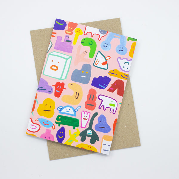 Front view of the creatures card print. Multiple different monsters and creatures on a pink background. 