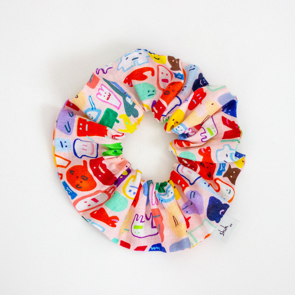 Colorful scrunchie with cartoon character design on a white background