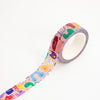 A roll of washi tape with a pastel multicolour cartoon monster pattern, shown partially unrolled on a clean white background.