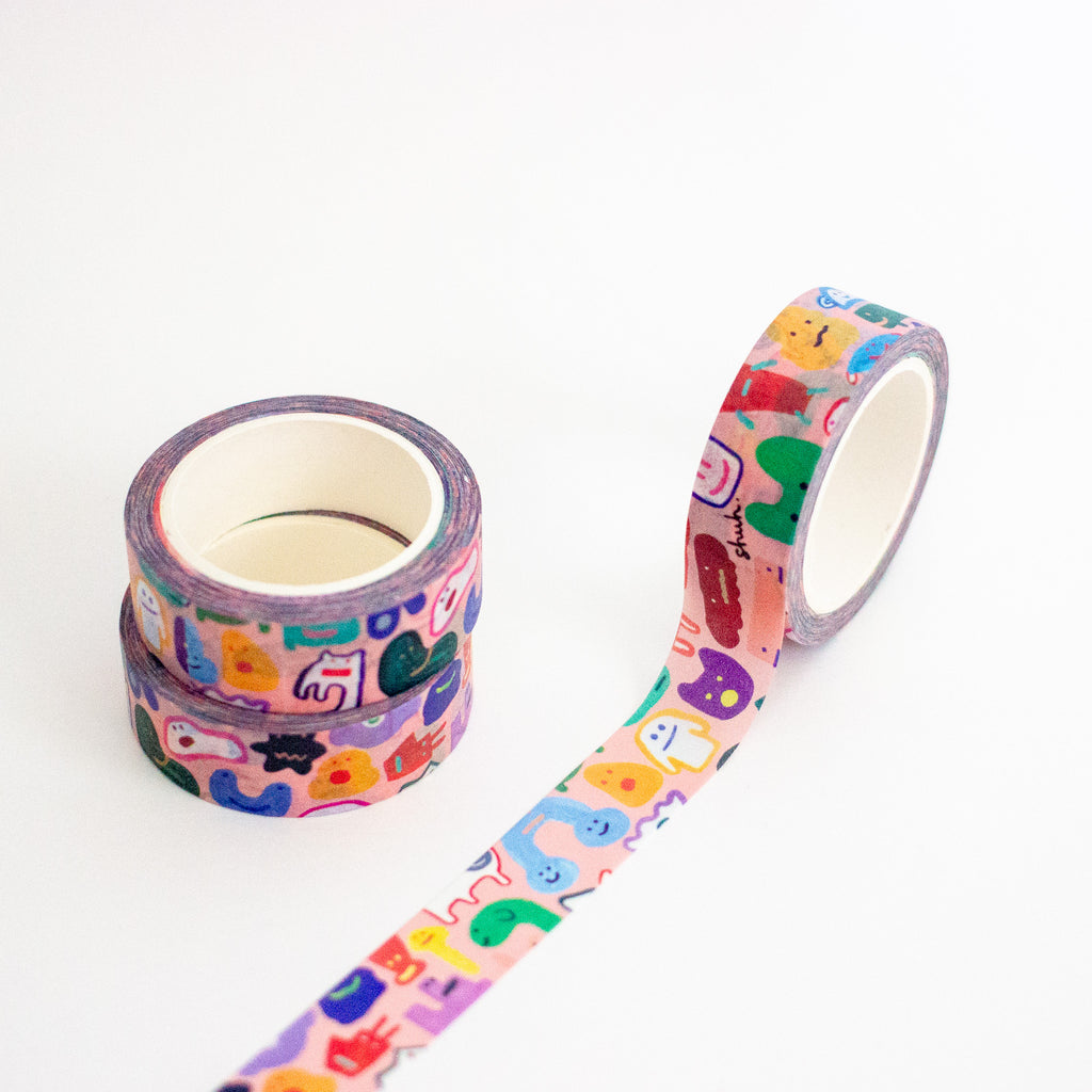 Three rolls of washi tape with a colourful cartoon monster pattern, displayed on a clean white background.