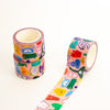 Three rolls of washi tape with a colourful cartoon character pattern on a light pink background, arranged on a clean white surface.