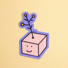 A die-cut sticker featuring a cute cartoon character with a yellow flower on its head, set against a plain light yellow background.