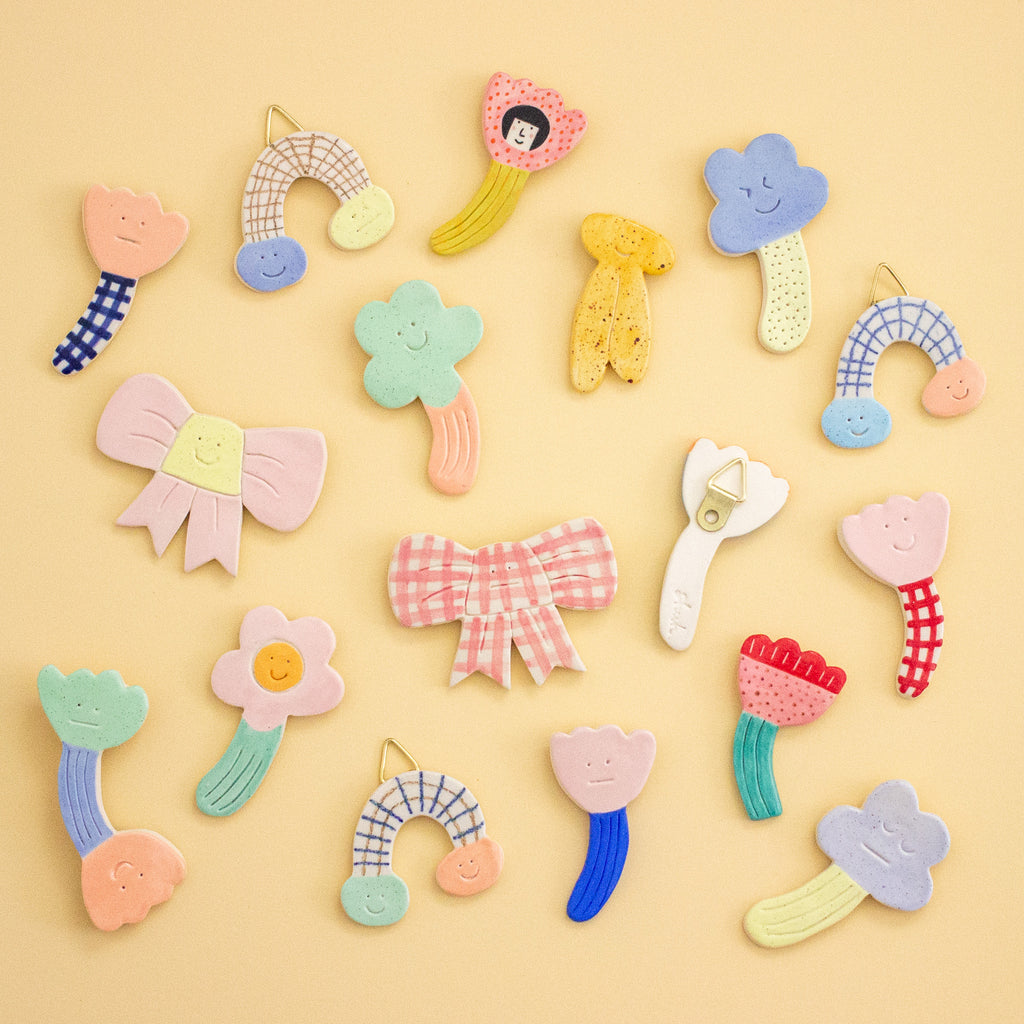 Colorful ceramic wall art pieces on a yellow background