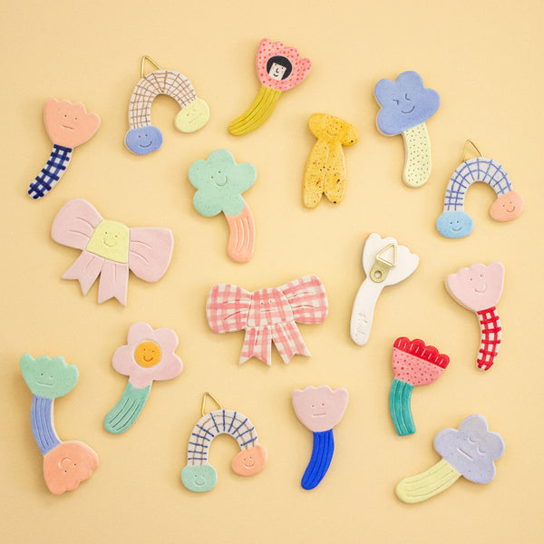 Colorful ceramic wall art pieces on a yellow background