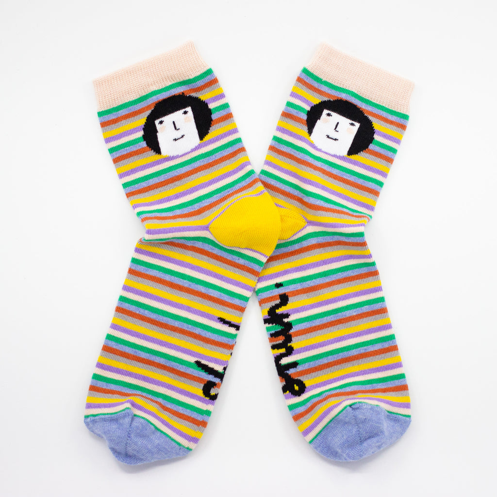 Side view of the shuh. cutie socks. Bright striped background with shuh. girl face. Yellow heel. 