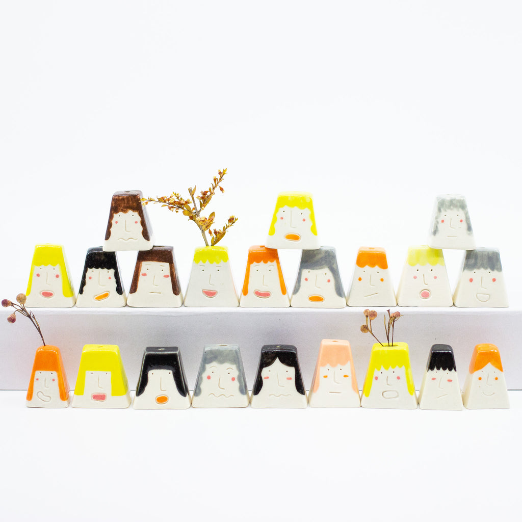 A front view of the entire collection of classroom incense or flower stem holders. 