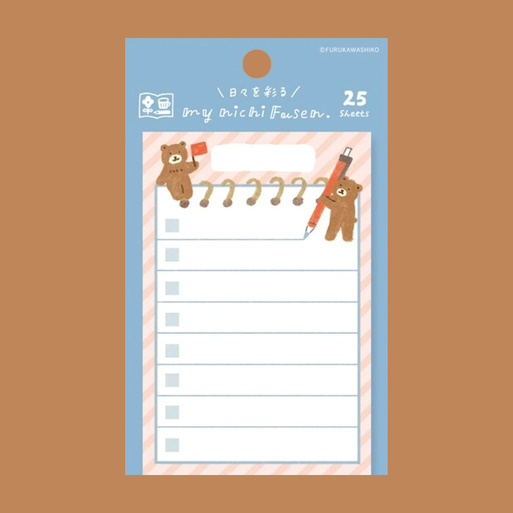 A sheet of 25 small sticky notes, featuring cute cartoon teddy bears holding a red flag and a red pencil on a light blue and pink striped background, displayed on a solid brown background.