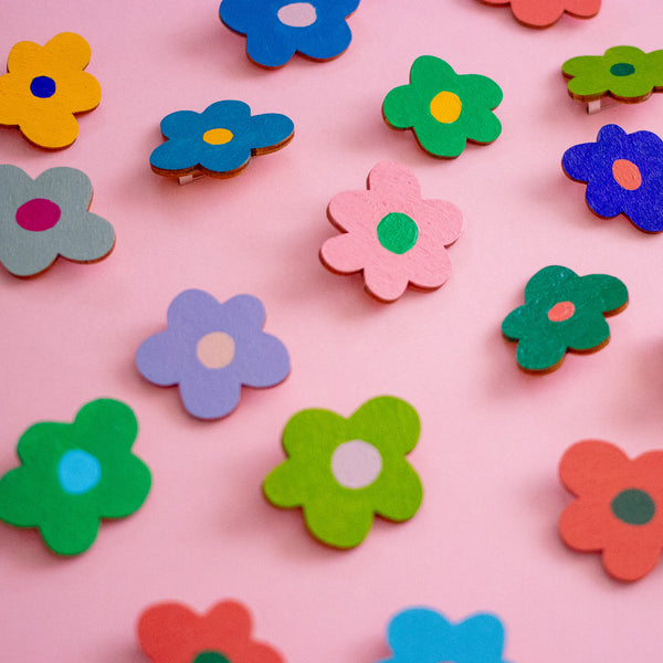 Colourful flower-shaped objects on a pink background