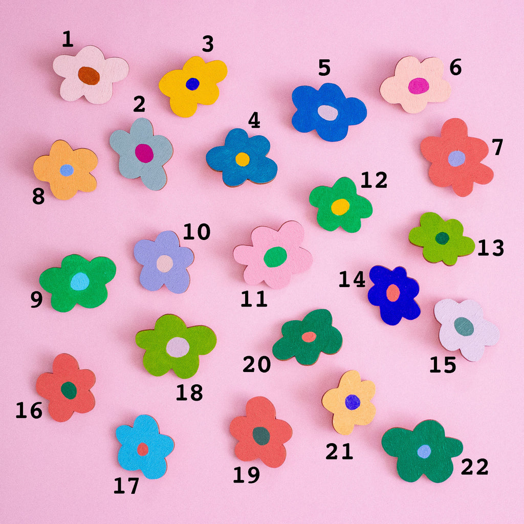Colourful flower-shaped objects with numbers on a pink background
