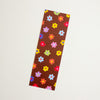 A colourful floral-patterned bookmark with pink, red, purple, orange, yellow, green, and blue flowers, shown against a plain white background.