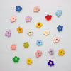 Colourful flower-shaped objects on a light grey background