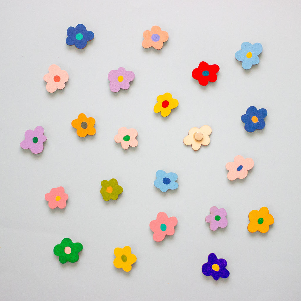 Colourful flower-shaped objects on a light grey background