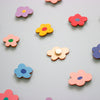 Colourful flower-shaped objects on a light grey background
