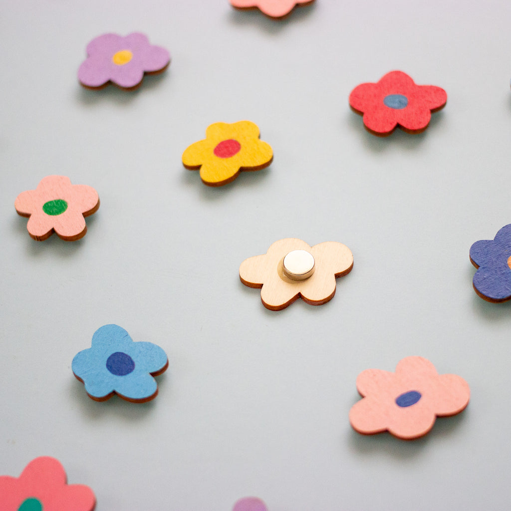 Colourful flower-shaped objects on a light grey background