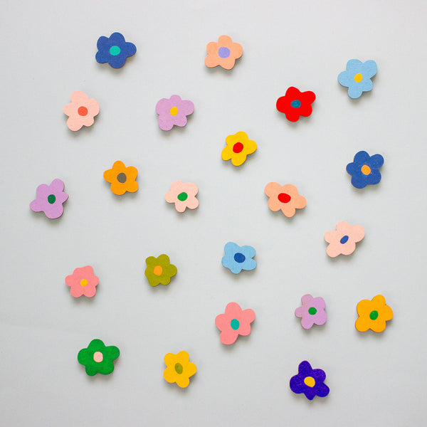 Colourful flower-shaped objects on a light grey background