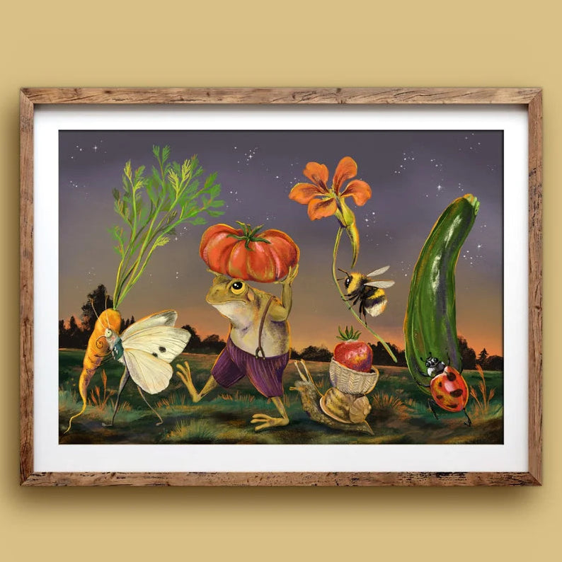A framed art print featuring a whimsical surrealist illustration of vegetables and insects under a starry night sky, displayed on a warm beige wall.