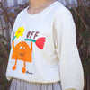Side view of a Person wearing a beige long sleeve t-shirt with a colourful graphic of an orange cartoon character holding two flowers and the words "DAY OFF" in playful text. Design by shuh., printed in Australia.