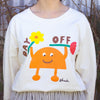 Front close up of Person wearing a beige long sleeve t-shirt with a colourful graphic of an orange cartoon character holding two flowers and the words "DAY OFF" in playful text. Design by shuh., printed in Australia.

