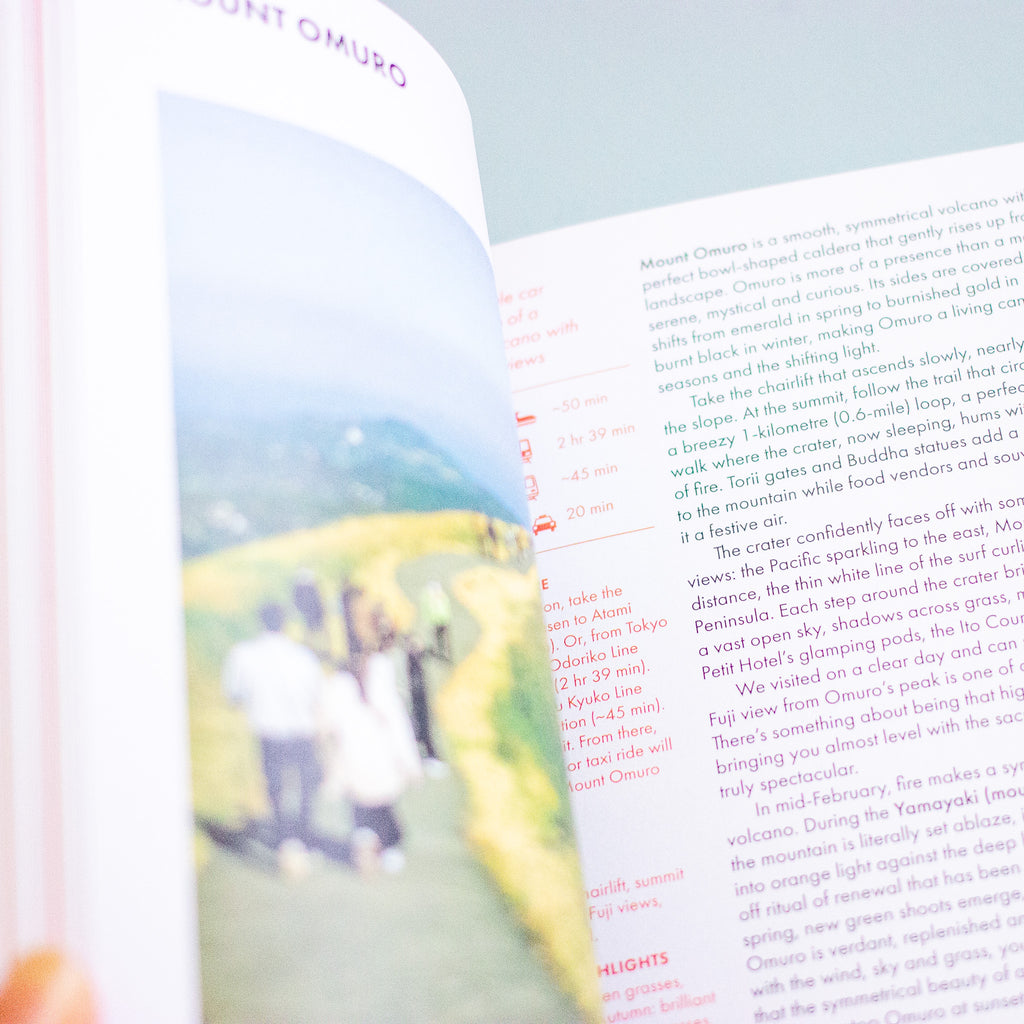 An open book showing printed text and a map, photographed close up with a blurred yellow foreground element at the bottom right.
