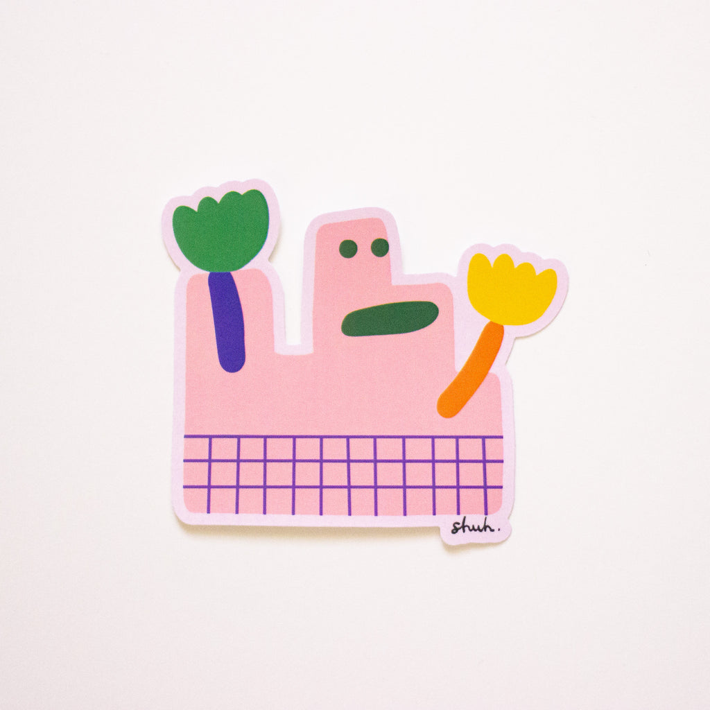 The dolly vinyl sticker. Pink monster with flower hands and green smile!