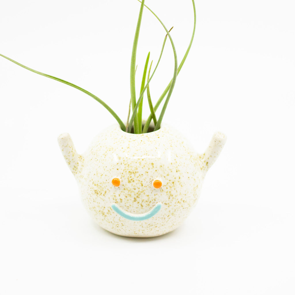 Front view of don vase. Natural glaze and blue smile. 