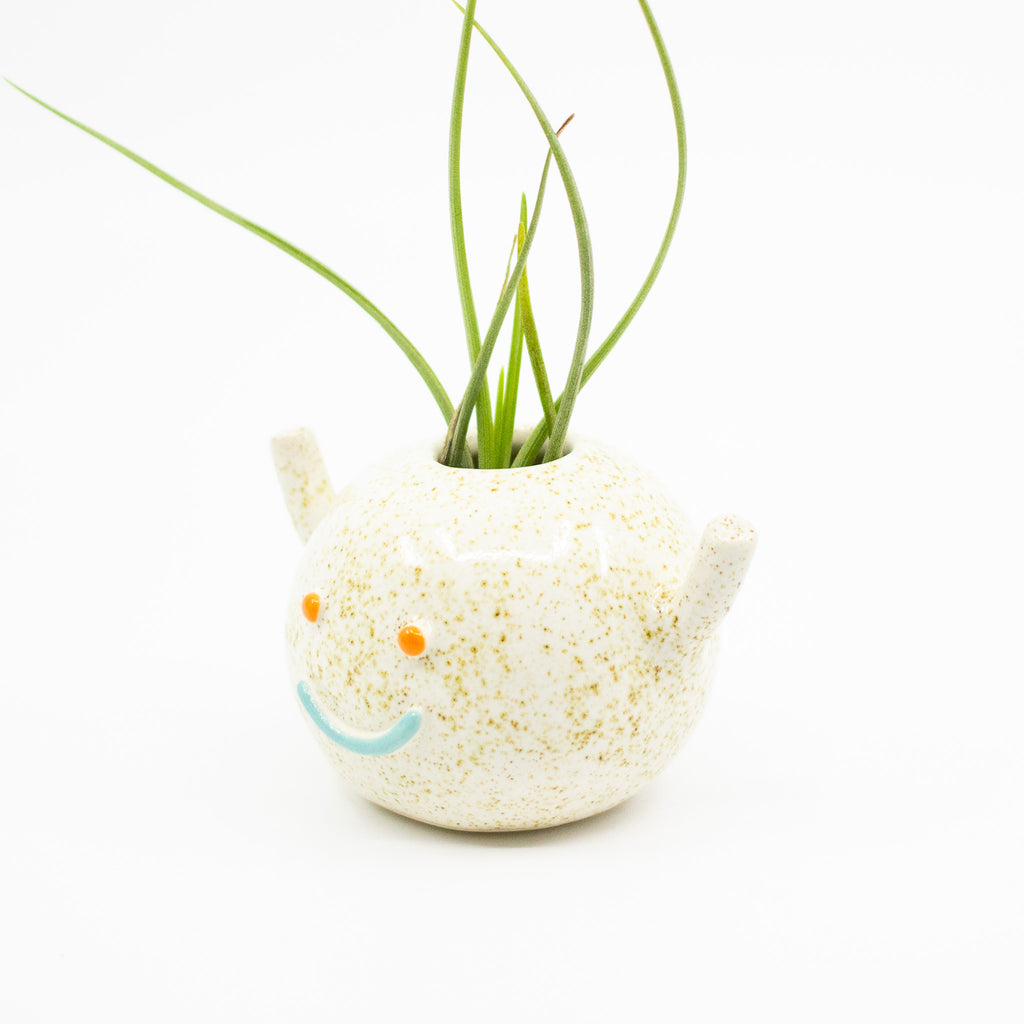 Side view of don vase. Natural glaze and blue smile. 