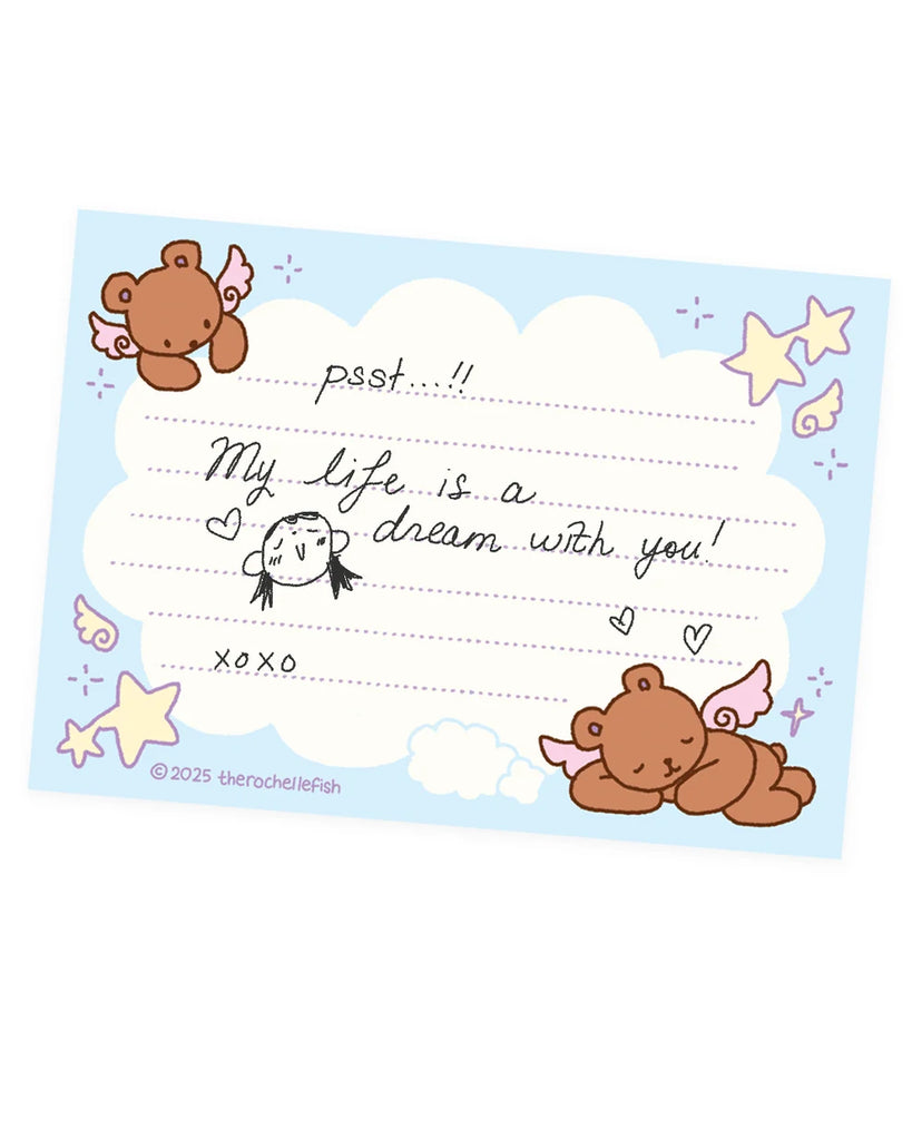 A blue pack of cute message cards featuring cartoon teddy bears, stars, stars, and wings, and writing sections with handwritten-style text including 'psst...My life is a dream with you!' and 'xoxo.