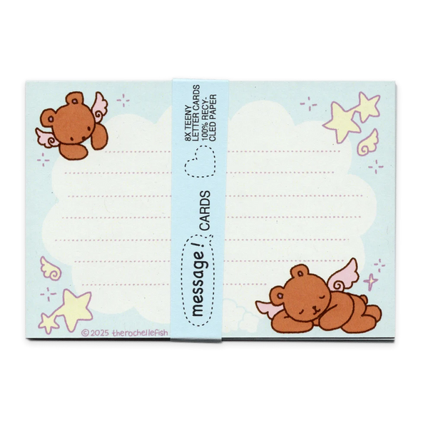 A blue pack of cute message cards featuring cartoon teddy bears, stars, stars, and wings, wrapped with a blue paper band labeled 'message cards'.