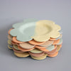 Stack of colorful ceramic plates on a gray background