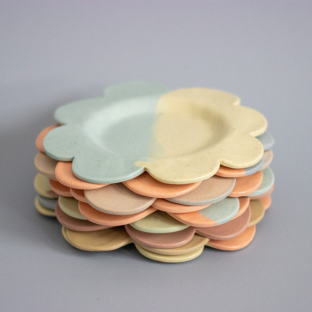 Stack of colorful ceramic plates on a gray background