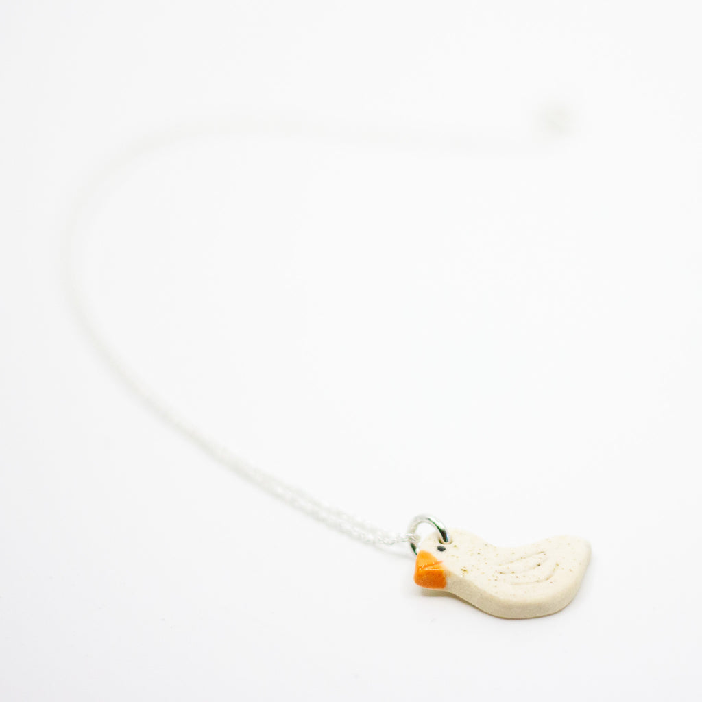 White Duck-shaped necklace on a white background