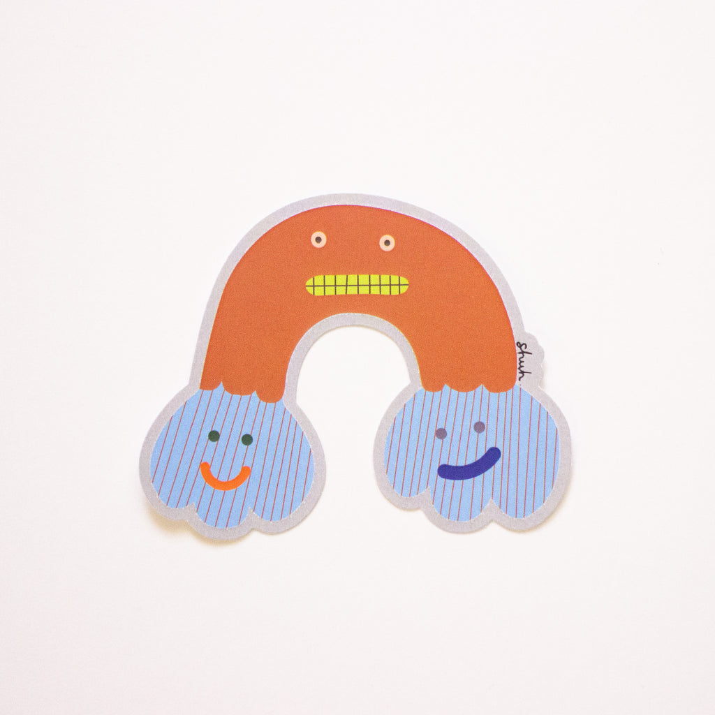 Ernie sticker, a rainbow shaped monster with cloud feet. Orange and blue. 