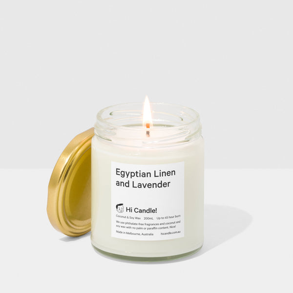 Candle in a glass jar with a label on a white background