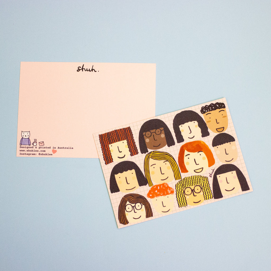 A postcard featuring two pink coloured postcards on a light blue background. The postcard on the bottom shows the back design and has the logo word 'shuh.' on top. 