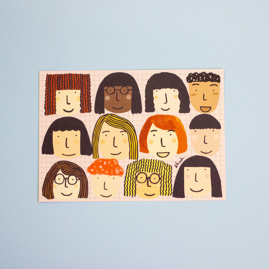 A postcard featuring a grid of twelve stylised cartoon faces with diverse hair, skin tones, and glasses, displayed against a solid light blue background.